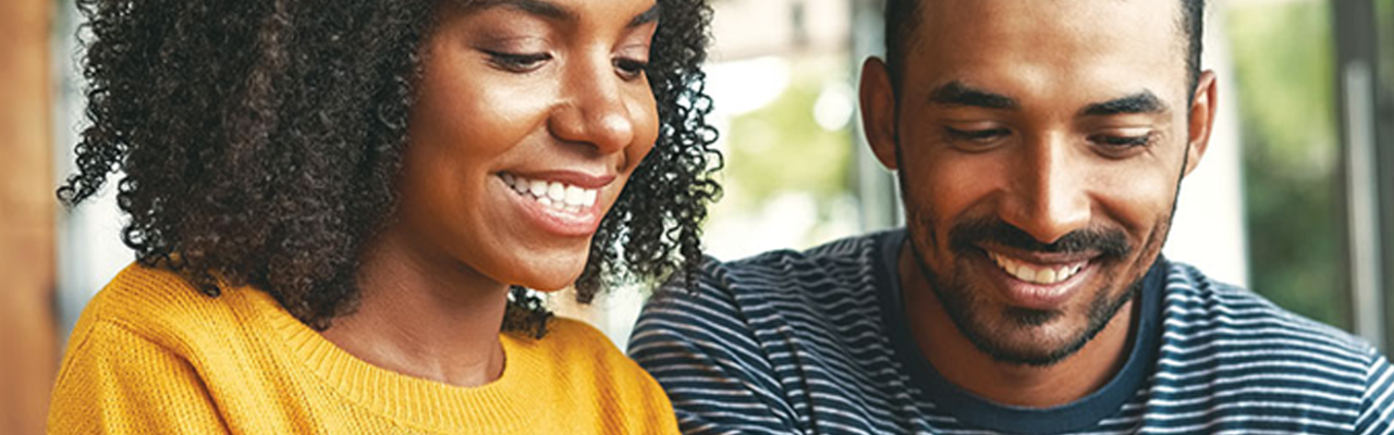 SSB Smart Card Header: Couple looking at their phone holding their debit card