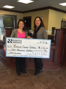 Presenting a check to Options Board member Patti Tabatznik is Sawyer Savings Branch Manager Jenn Gutheil-Denier.