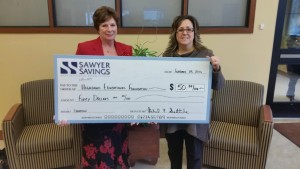 Highland Branch Manager, Liza Lanzarone is shown making a donation to the Highland Educational Foundation