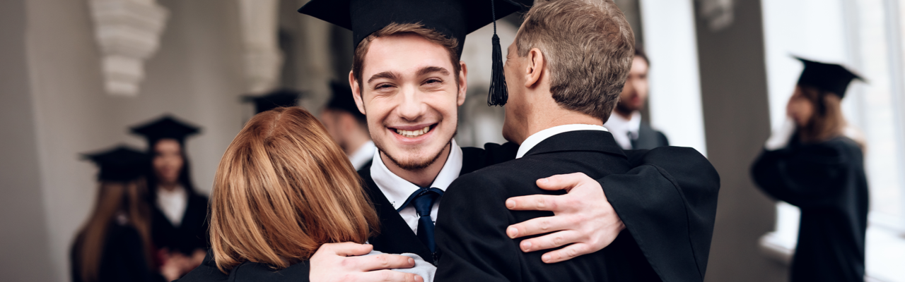 Graduating High school student hugging his parents