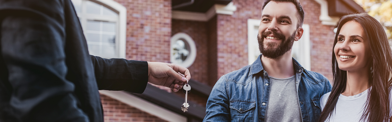 Handing off keys to a couple who just bought a house