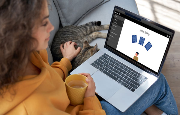 woman on laptop with cat looking at online video tutorials