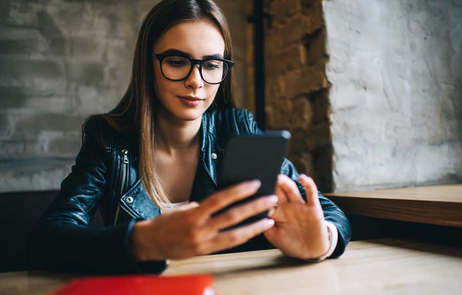 women using mobile phone but looks suspicious