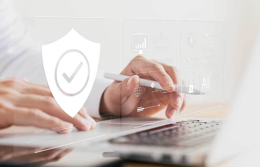 hands on laptop with security badge overlay